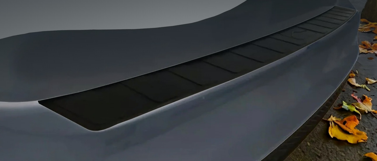 Black ABS rear bumper protector fitted to the boot lip of a silver car